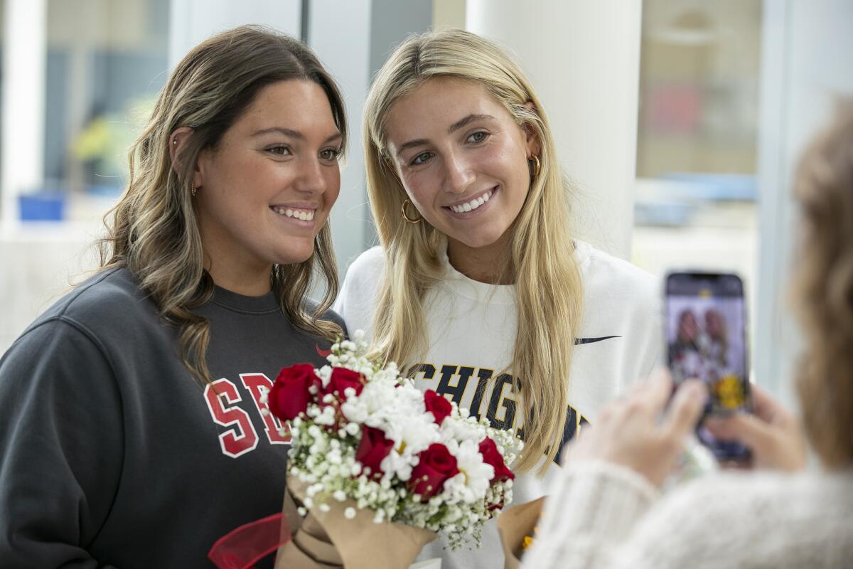 Makena Macedo, left, and Jillian Schlom pose for a photo during Corona del Mar High School signing day on Monday.