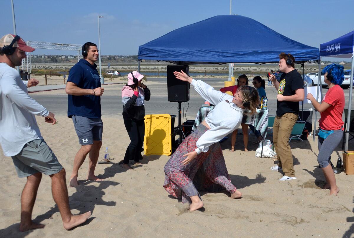 About eight volunteers at the Loving Life Music Festival on Bolsa Chica State Beach.