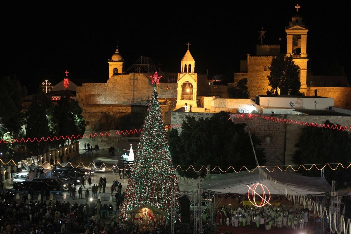 A view of Manger Square and the Church of the Nativity as people gather for Christmas Eve celebrations in the Bethlehem.