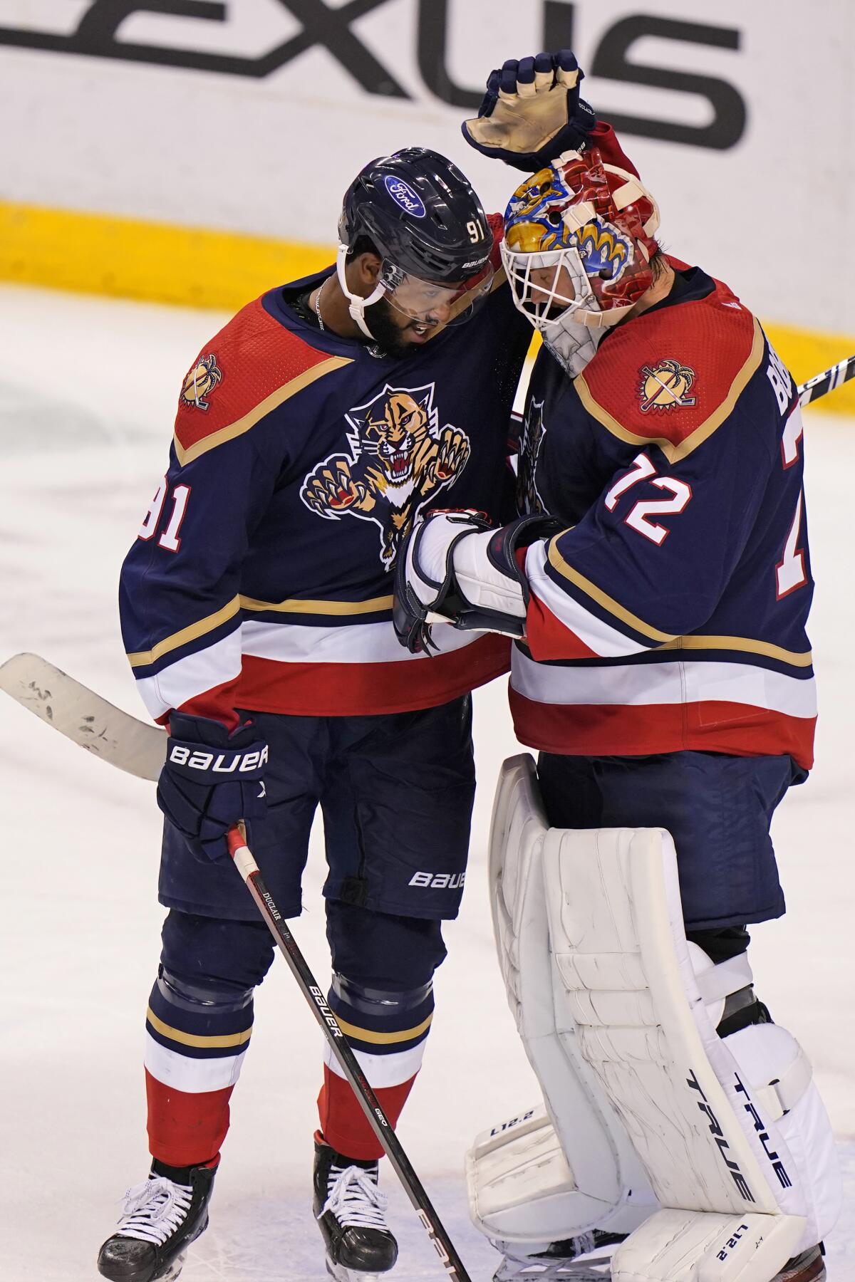 Florida Panthers goaltender Sergei Bobrovsky (72) and left wing Anthony Duclair (91) congratulate each other after the Panthers defeated the Chicago Blackhawks 4-2 in an NHL hockey game Saturday, March 13, 2021, in Sunrise, Fla. (AP Photo/Wilfredo Lee)