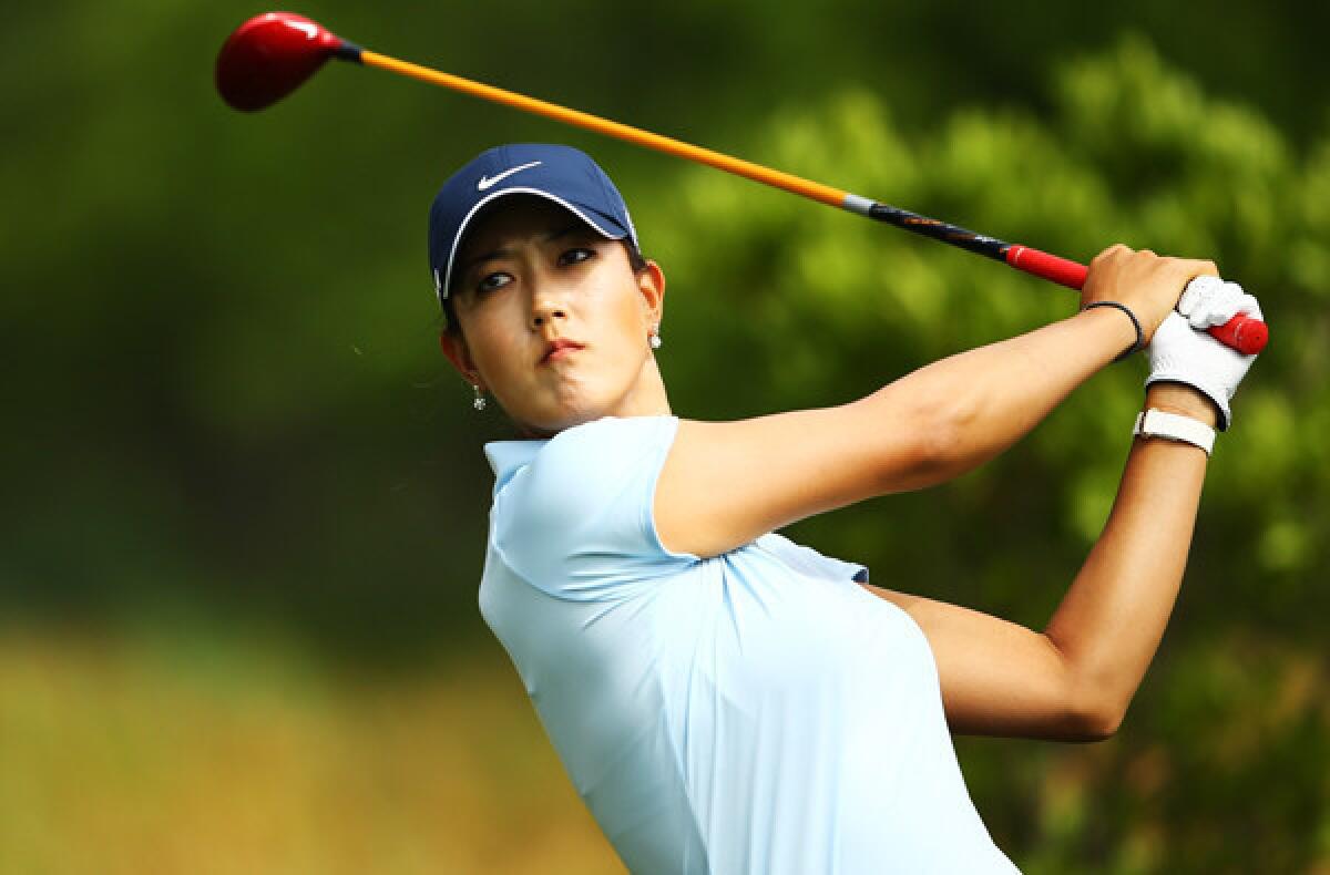 Michelle Wie tees off on the eighth hole during the second round of the U.S. Women's Open on Friday. Wie dropped out of the tournament Saturday, citing illness.