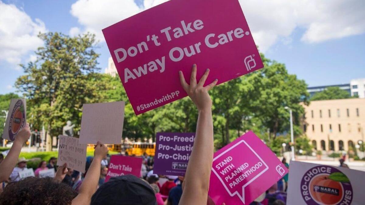 Supporters of abortion rights rally outside the Georgia capitol on May 7 after the state's governor signed legislation banning early abortions.