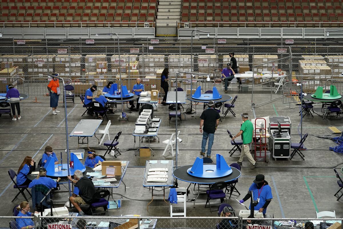 Ballots are examined by a private firm in Arizona. 