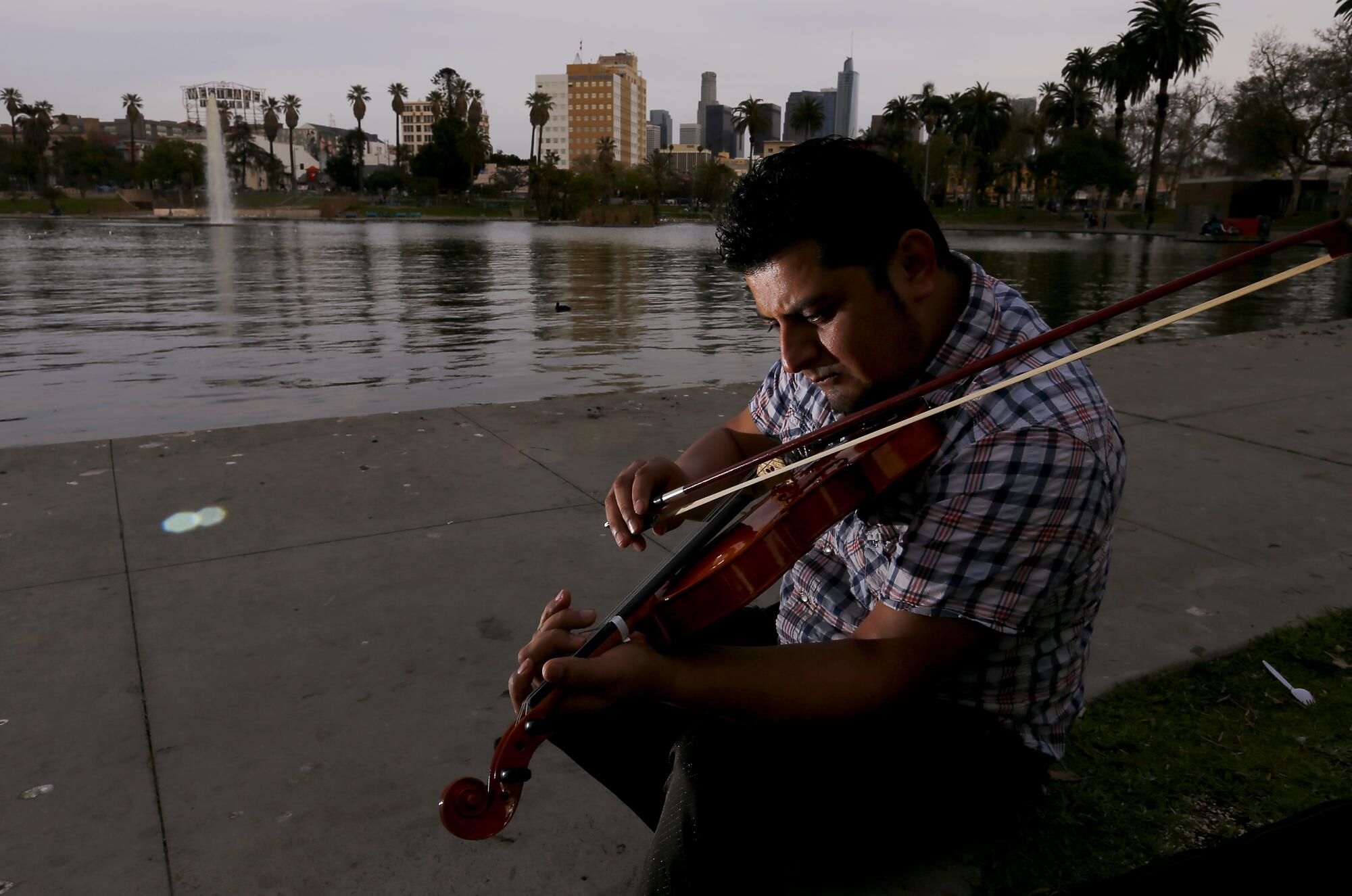 Osiel Ramirez plays violin at MacArthur Park in Westlake.