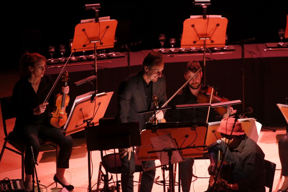 Richard Tognetti, center on violin, the artistic director of the Australian Chamber Orchestra, leads the ensemble in a performance of "The Reef."