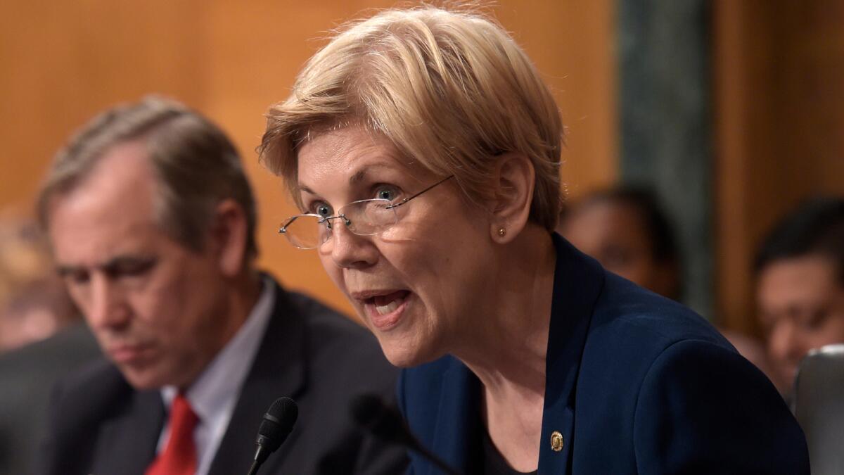 Sen. Elizabeth Warren, shown Sept. 20, is asking the U.S. Education Department to halt all collections on Corinthian College students' debt and discharge their federal loans.