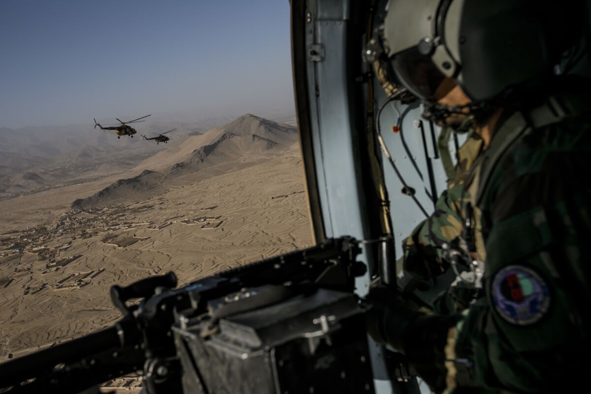 Lt. Obaidullah Haber, member of the 777 Special Mission Wing looks out from a Mi-17 helicopter during a training mission around Kabul, Afghanistan.