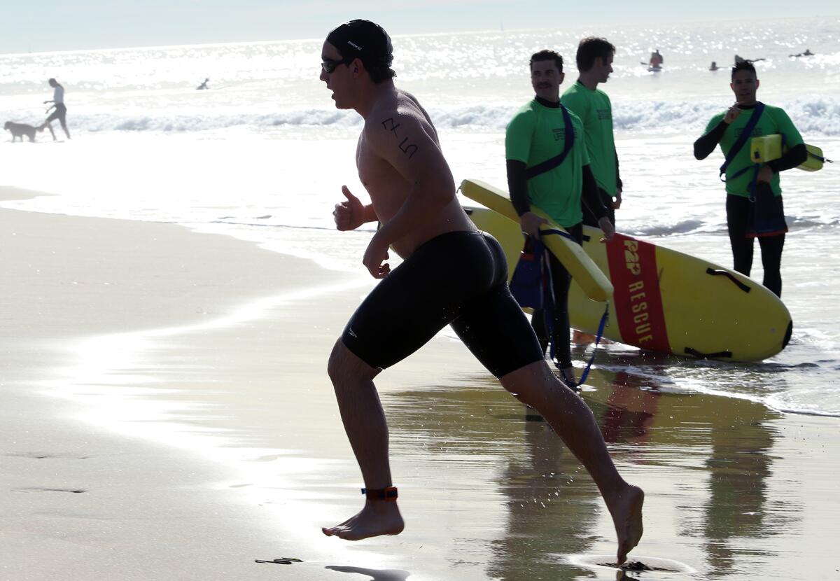 Robert Collins, 20, of Tustin, a Orange County Fire Cadet, runs to the finish line.