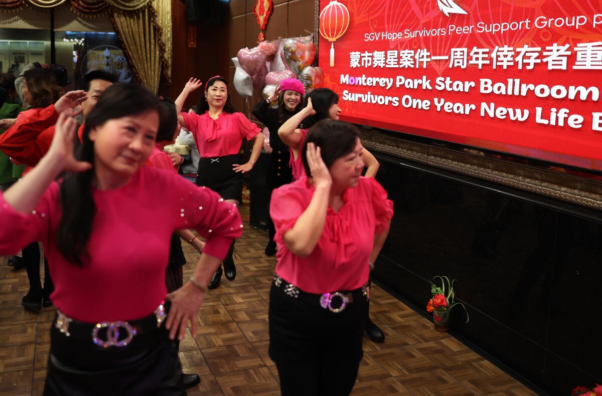 People dance during a survivors' banquet marking the anniversary of the Monterey Park mass shooting.