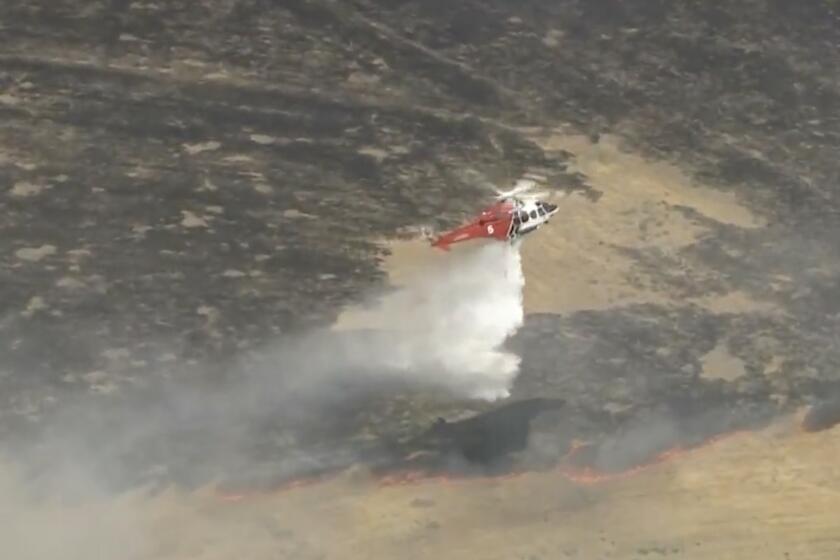 A brush fire that broke out Thursday afternoon was threatening homes in Sylmar, officials said. More than 100 firefighters were battling the blaze.