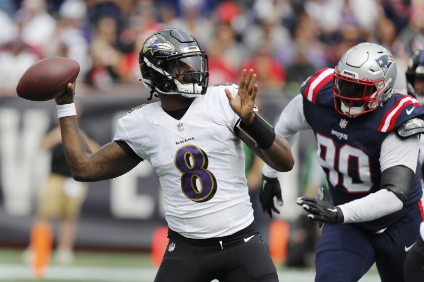 Baltimore Ravens quarterback Lamar Jackson (8) plays against the New England Patriots in the first half of an NFL football game, Sunday, Sept. 25, 2022, in Foxborough, Mass. (AP Photo/Paul Connors)