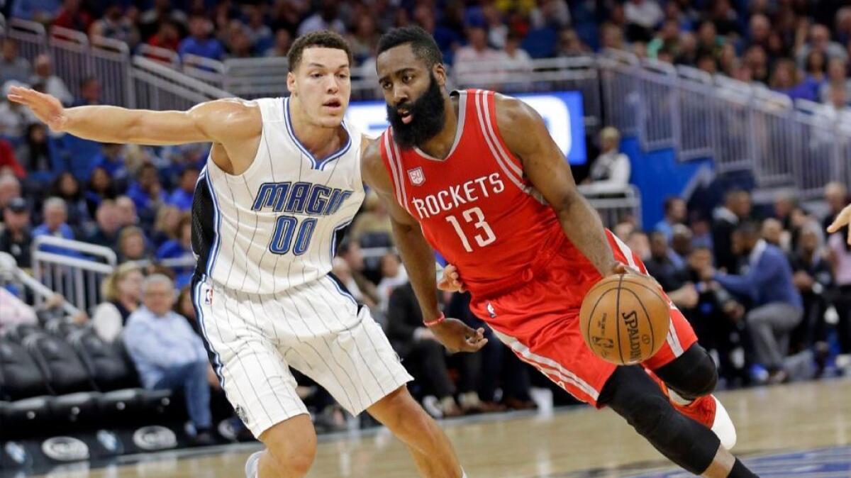 Rockets guard James Harden drives around Magic forward Aaron Gordon during the first half of a game in Orlando on Jan. 6.