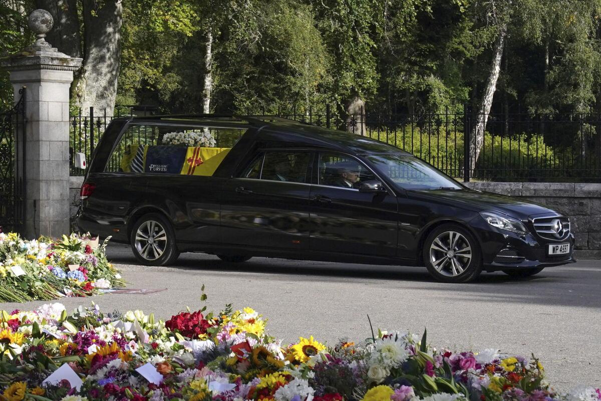 A hearse carrying the coffin of Queen Elizabeth II leaves her Scottish estate Balmoral Castle.