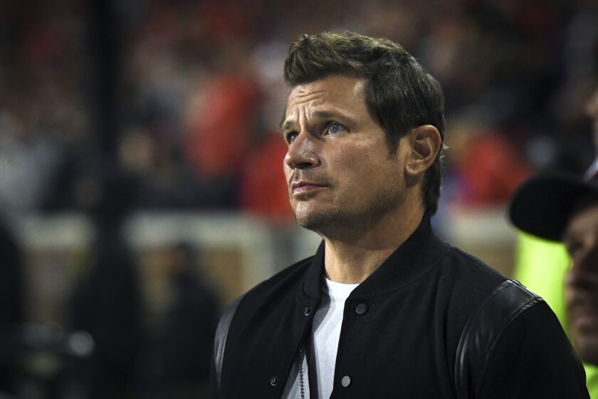 CINCINNATI, OH - NOVEMBER 06: Singer and television personality, Nick Lachey, stands on the sideline during a college football game between the Tulsa Golden Hurricane and Cincinnati Bearcats on November 6, 2021 at Nippert Stadium in Cincinnati, OH. (Photo by James Black/Icon Sportswire) (Icon Sportswire via AP Images)