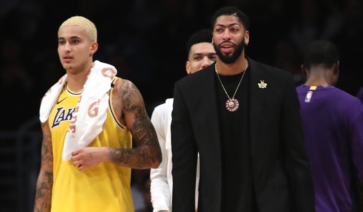 Anthony Davis, right, will miss his fourth consecutive game while recovering from a bruised gluteous maximus. Kyle Kuzma, left, has started in his place. 