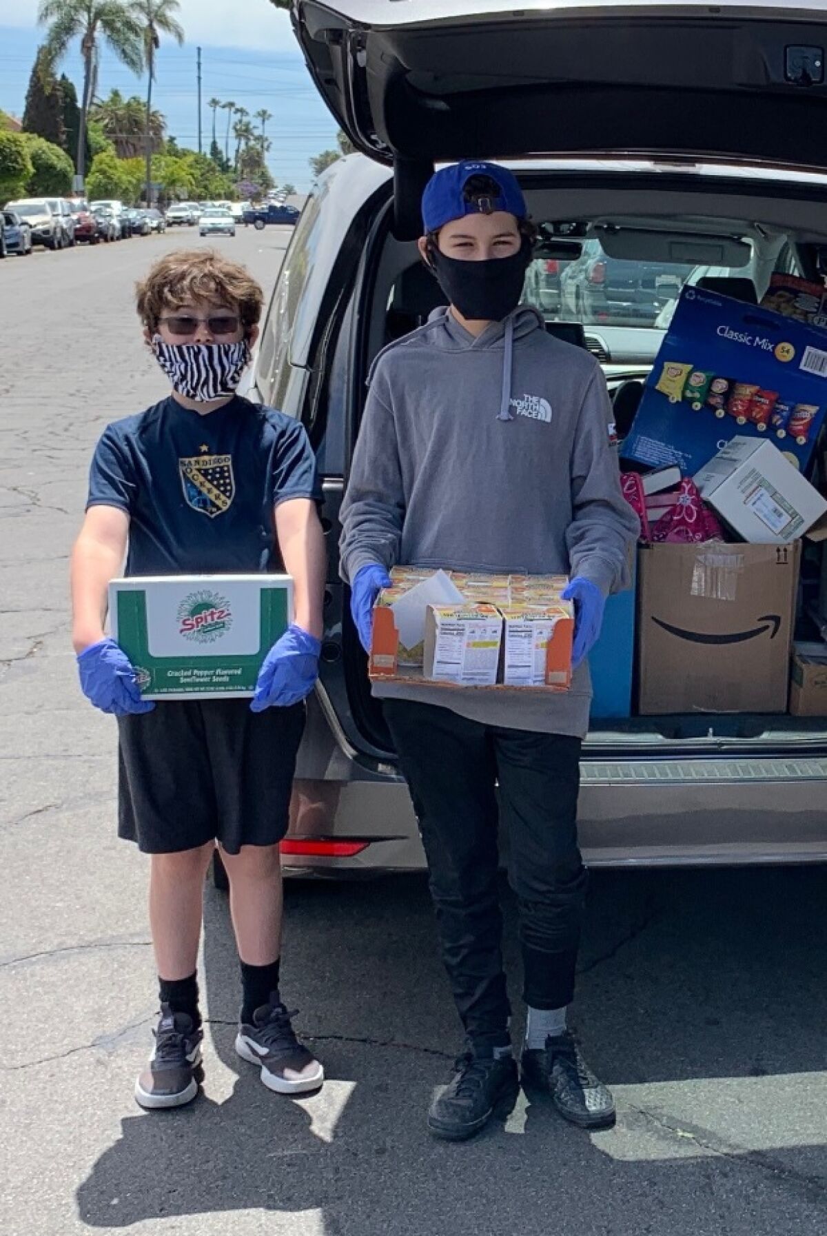 Zac and Asher Swazey delivering donations to Barrio Logan neighbors.