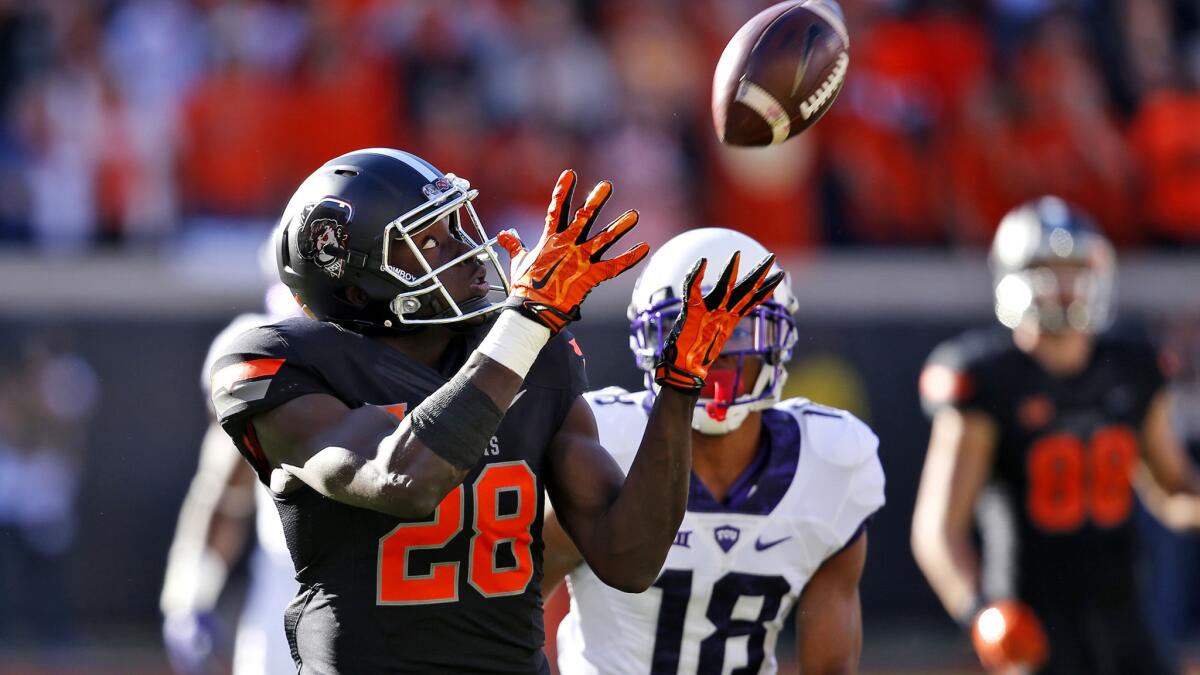 Oklahoma State wide receiver James Washington (28) beats TCU safety Nick Orr (18) for a touchdown in the first quarter Saturday.
