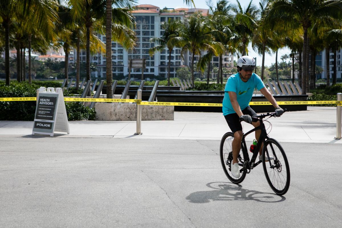 A man rides his bike in Miami Beach, Fla.