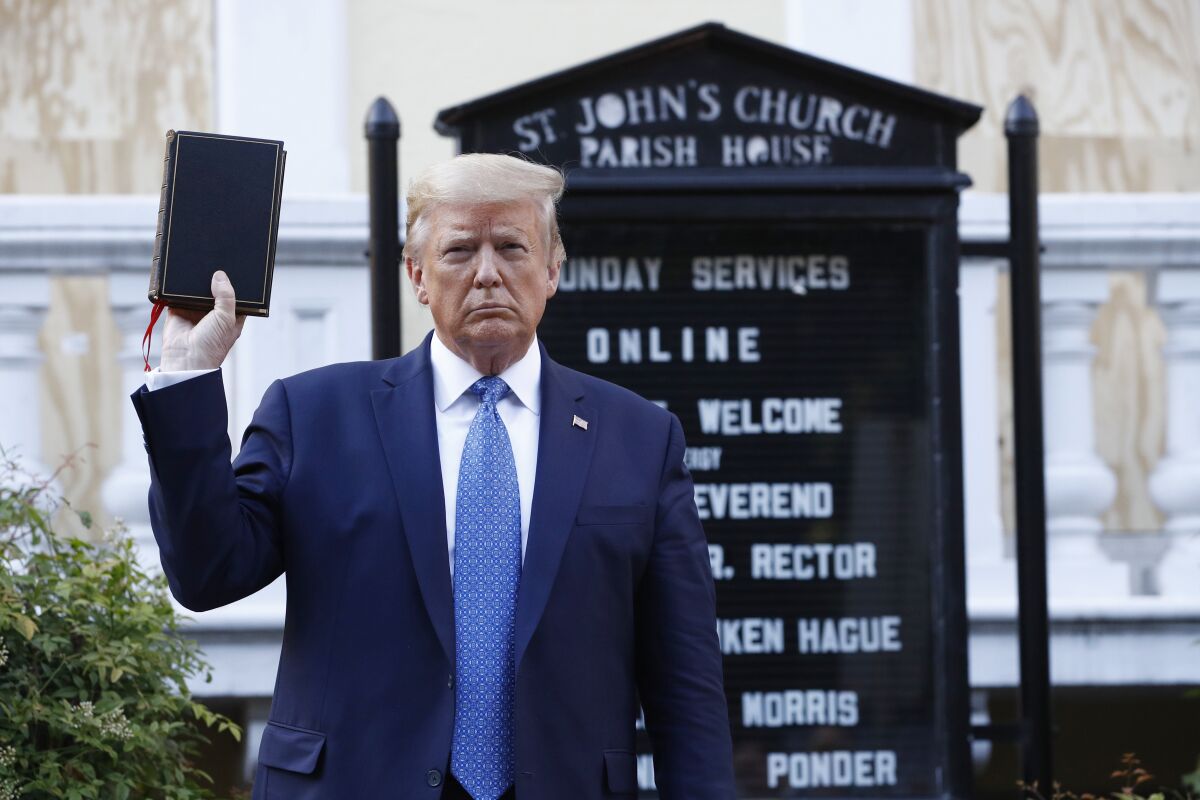 President Trump holds a Bible outside St. John's Church across Lafayette Park from the White House