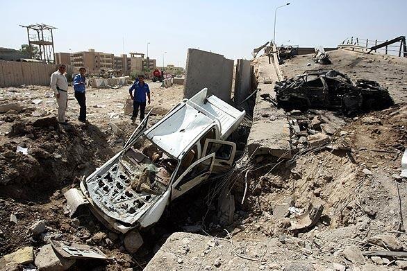 in the northern Baghdad neighborhood of Waziriyah, Iraqi police inspect the damage to the Mohammad Qassem bridge. The bombings came at a time when the insurgency appears to be making a concerted effort to undermine faith in the ability of the Iraqi army and police to sustain security.