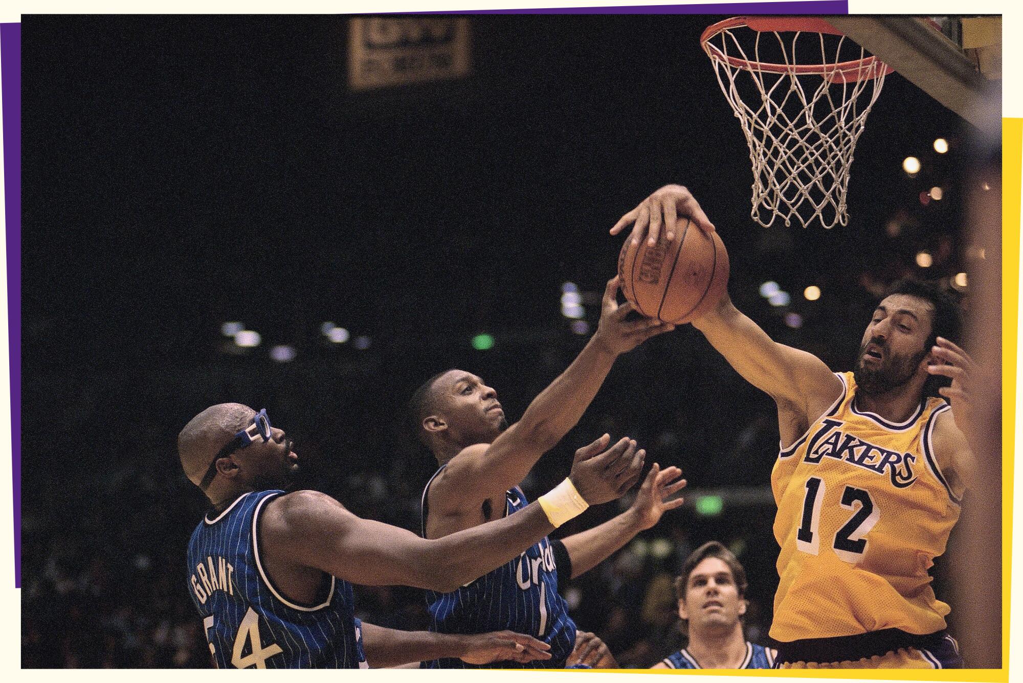 A photo of a player in a yellow jersey on right grabbing a ball under a basket as two other players reach for the ball.