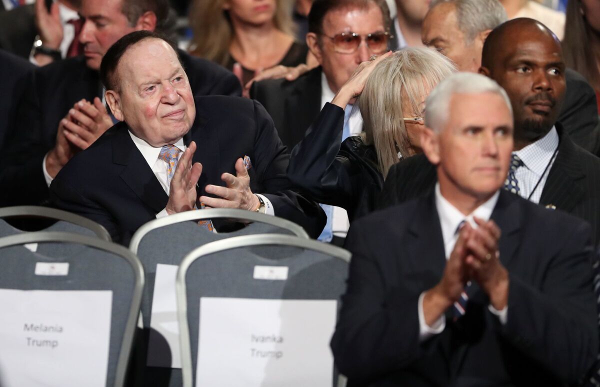 Businessman Sheldon Adelson, left, and Republican candidate for vice president Mike Pence applaud before the first presidential debate at Hofstra University in Hempstead, N.Y., on Sept. 26, 2016.