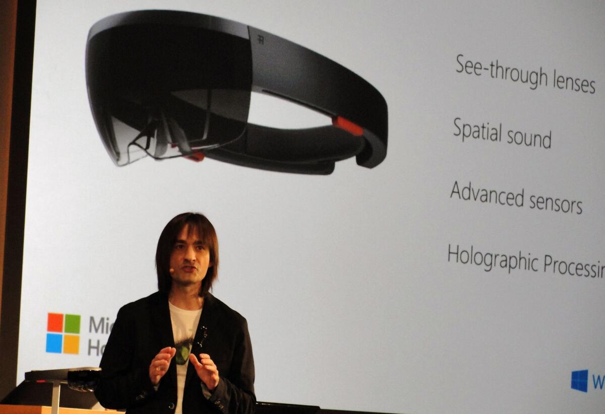Microsoft executive Alex Kipman speaks at the firm's Redmond, Wash., campus on Wednesday as he introduces HoloLens headgear that overlays 3-D objects on the real world.