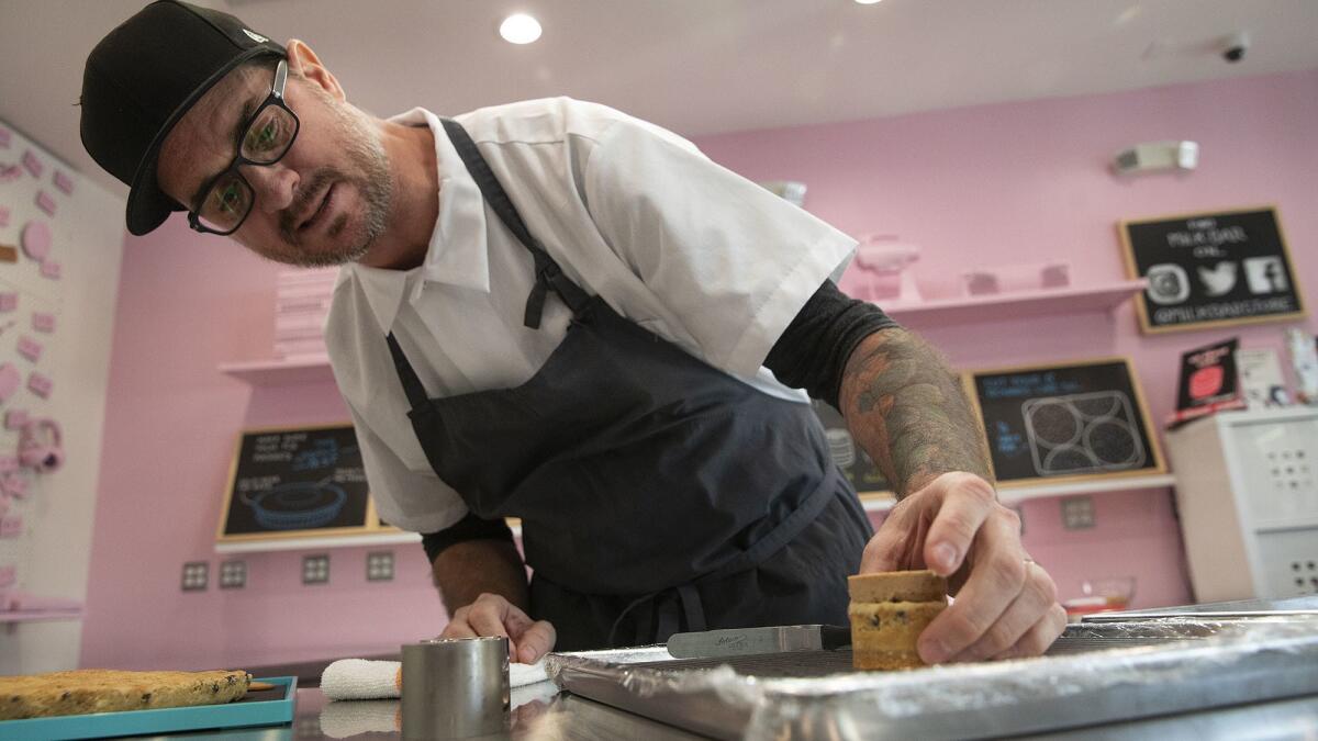Scotty Blenkarm, head of the R&D Lab at Milk Bar in Los Angeles, holds a Compost cookie cake that is under development.