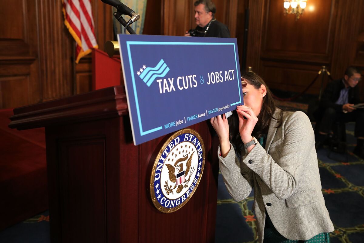 A Tax Cuts and Jobs Act sign is posted in 2017 in the Rayburn Room in the Capitol Building in Washington, D.C.
