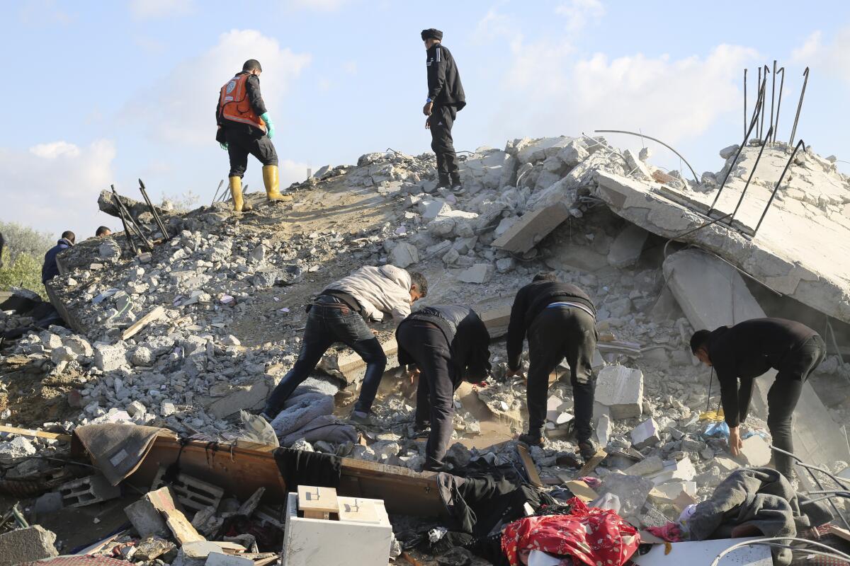 Palestinians search for survivors after an Israeli airstrike on a residential building in Rafah on Saturday. 