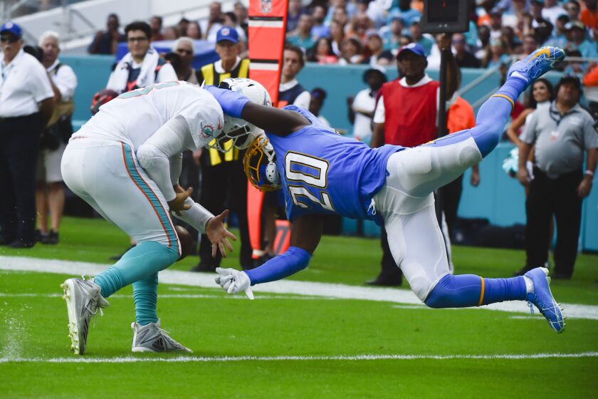 MIAMI, FL - SEPTEMBER 29: Desmond King #20 of the Los Angeles Chargers tackles Josh Rosen #3 of the Miami Dolphins during the third quarter of the game at Hard Rock Stadium on September 29, 2019 in Miami, Florida. (Photo by Eric Espada/Getty Images)