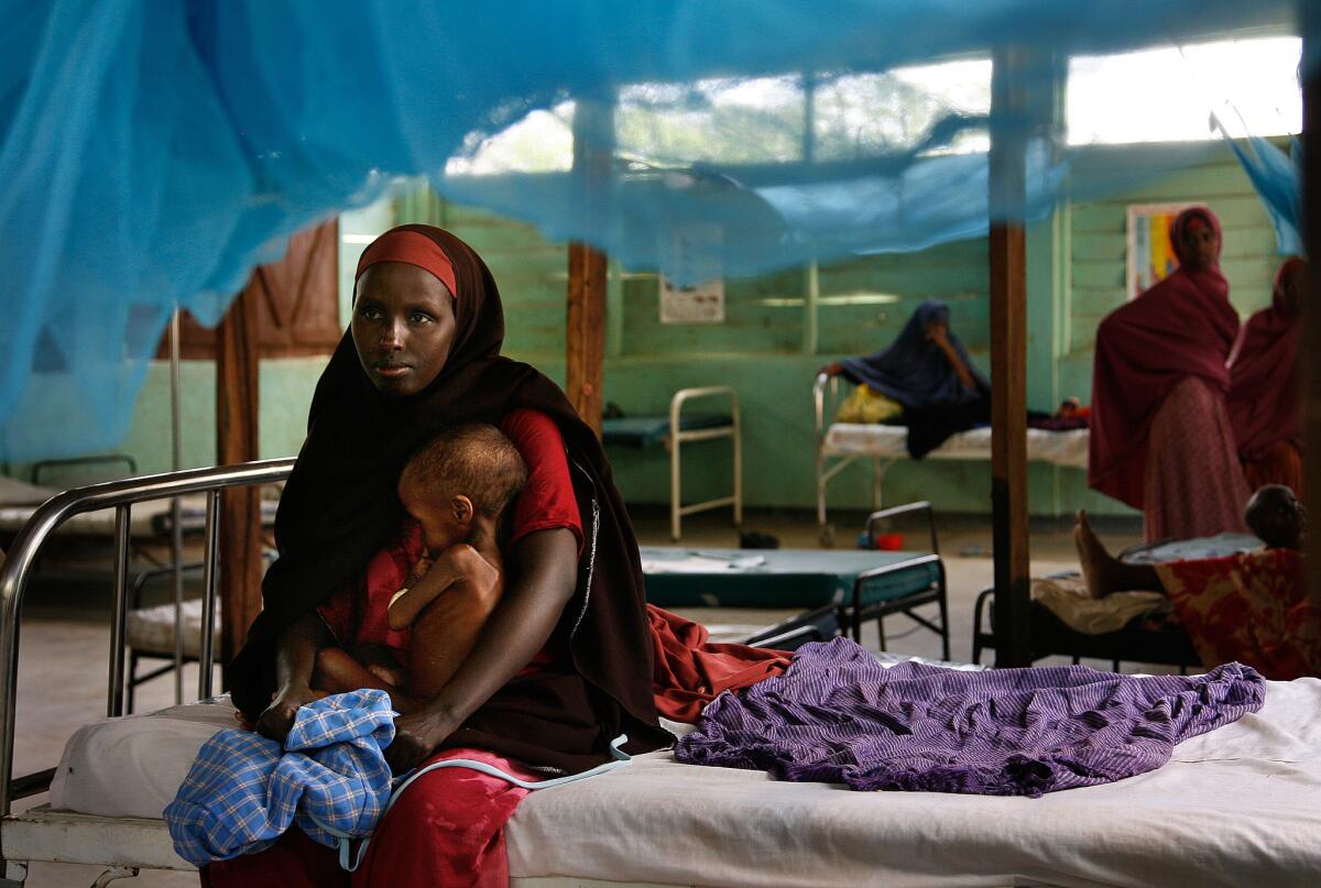 A woman holds a severely malnourished child at the Ifo camp in Dadaab. More people die of hunger-related causes every year than succumb to AIDS, malaria and tuberculosis combined.