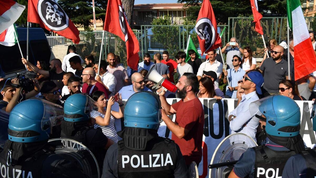 Police keep tabs on far-right wing activists in Rome during a protest in August 2018 against the arrival of migrants.