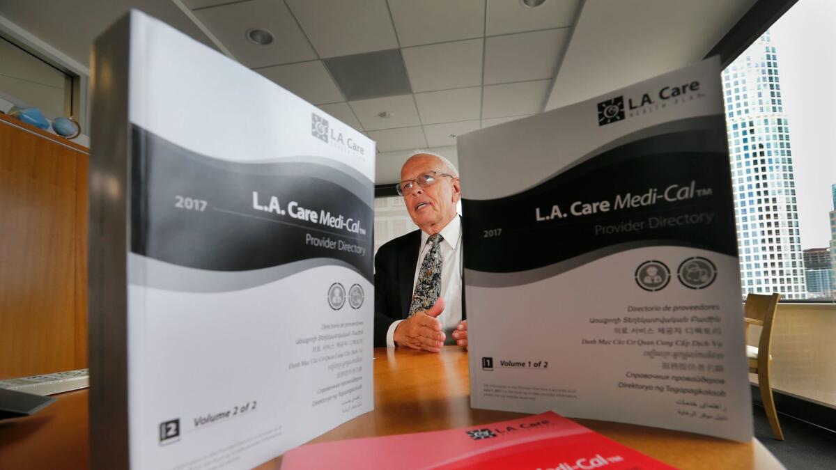 John Baackes, chief executive of L.A. Care Health Plan, is shown with two volumes of its 2017 provider directory, totaling 2,546 pages.