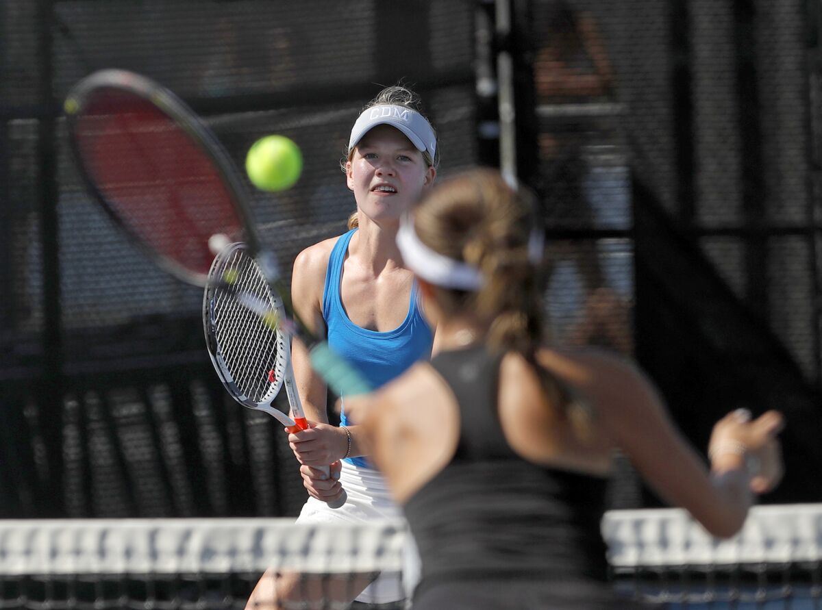 Louise Eriksson of Corona del Mar battles her Peninsula opponent at the net during Tuesday's nonleague match.