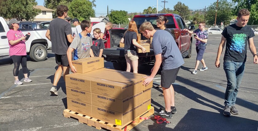 Volunteers unload boxes of pantry staples provided by The Church of Jesus Christ of Latter-day Saints.