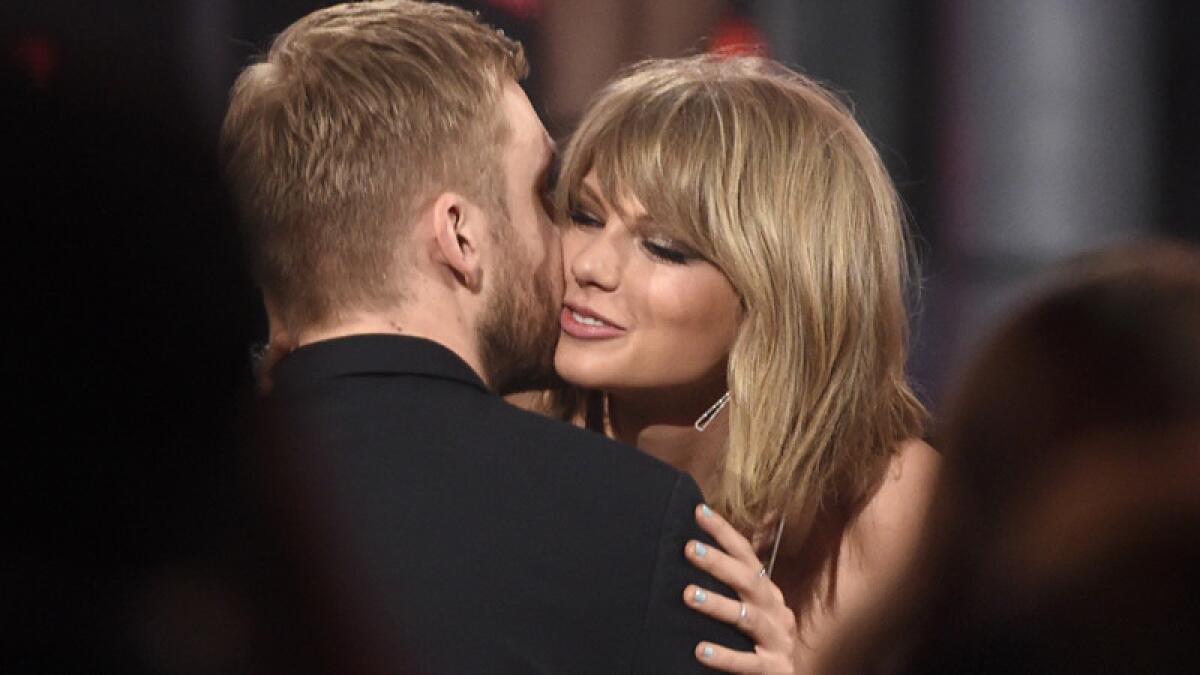 Taylor Swift hugs boyfriend Calvin Harris after winning the award for top Billboard 200 album for "1989" at the Billboard Music Awards in Las Vegas in May.
