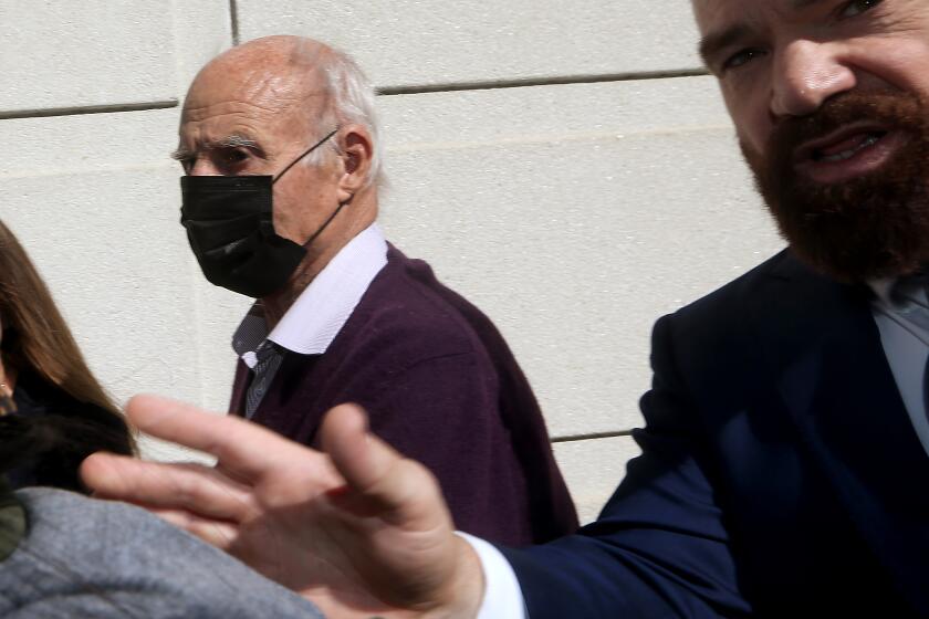 LOS ANGELES, CALIF. - FEB. 6, 2023. Tom Girardi, left, arrives for an initial court appearance at the Edward Roybal Federal Court Building in Los Angeles on Monday, Feb. 6, 2023, after being indicted by a federal grand jury for allegedly embezzling more than $15 million from several of his legal clients. (Luis Sinco / Los Angeles Times)