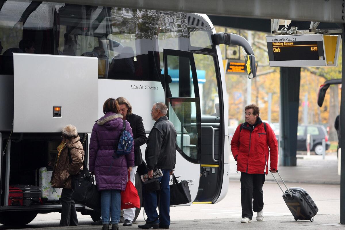 File photo shows passengers boarding a travel bus.