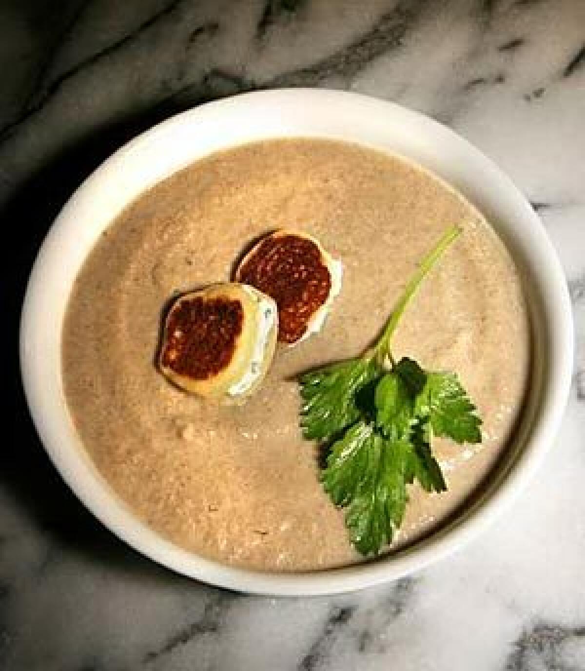 TEXTURE PERFECT: A mixed-mushroom velouté is enriched with just a little cream and topped with buttermilk blini.