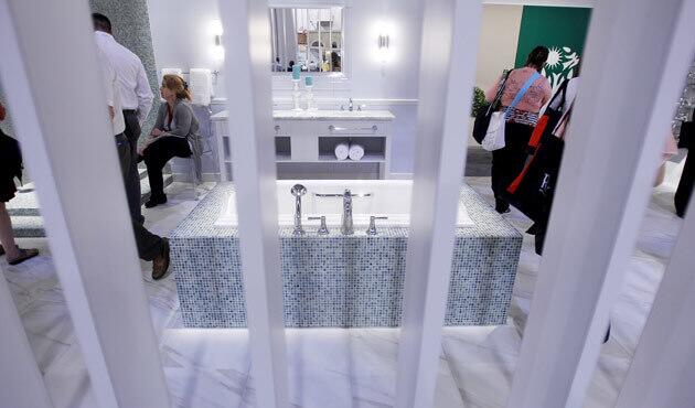 Conventiongoers check out a Toto bathroom display during the Kitchen & Bath Industry Show recently held in Las Vegas.