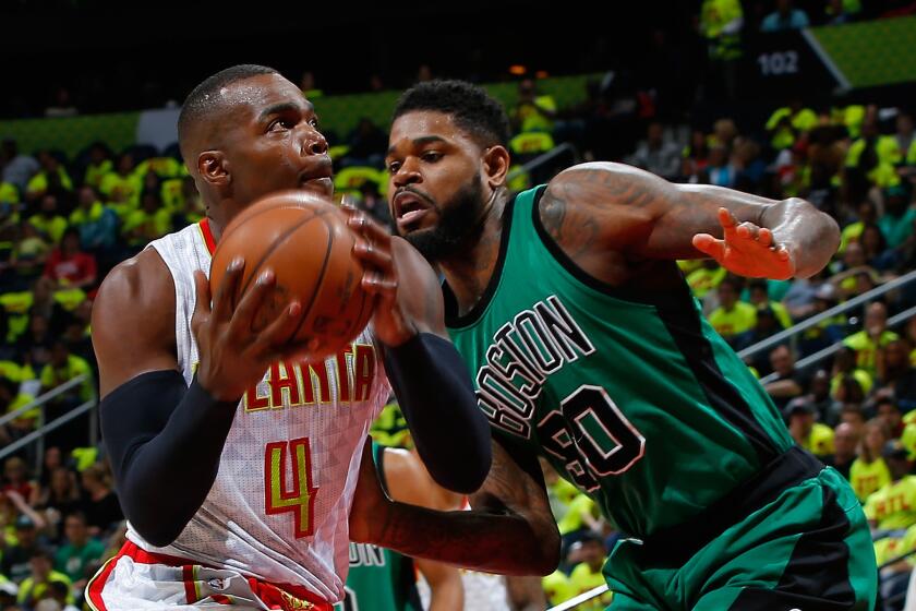 Atlanta's Paul Millsap drives against Boston's Amir Johnson during Game 1 of the Eastern Conference quarterfinal matchup between the Hawks and the Celtics on April 16.