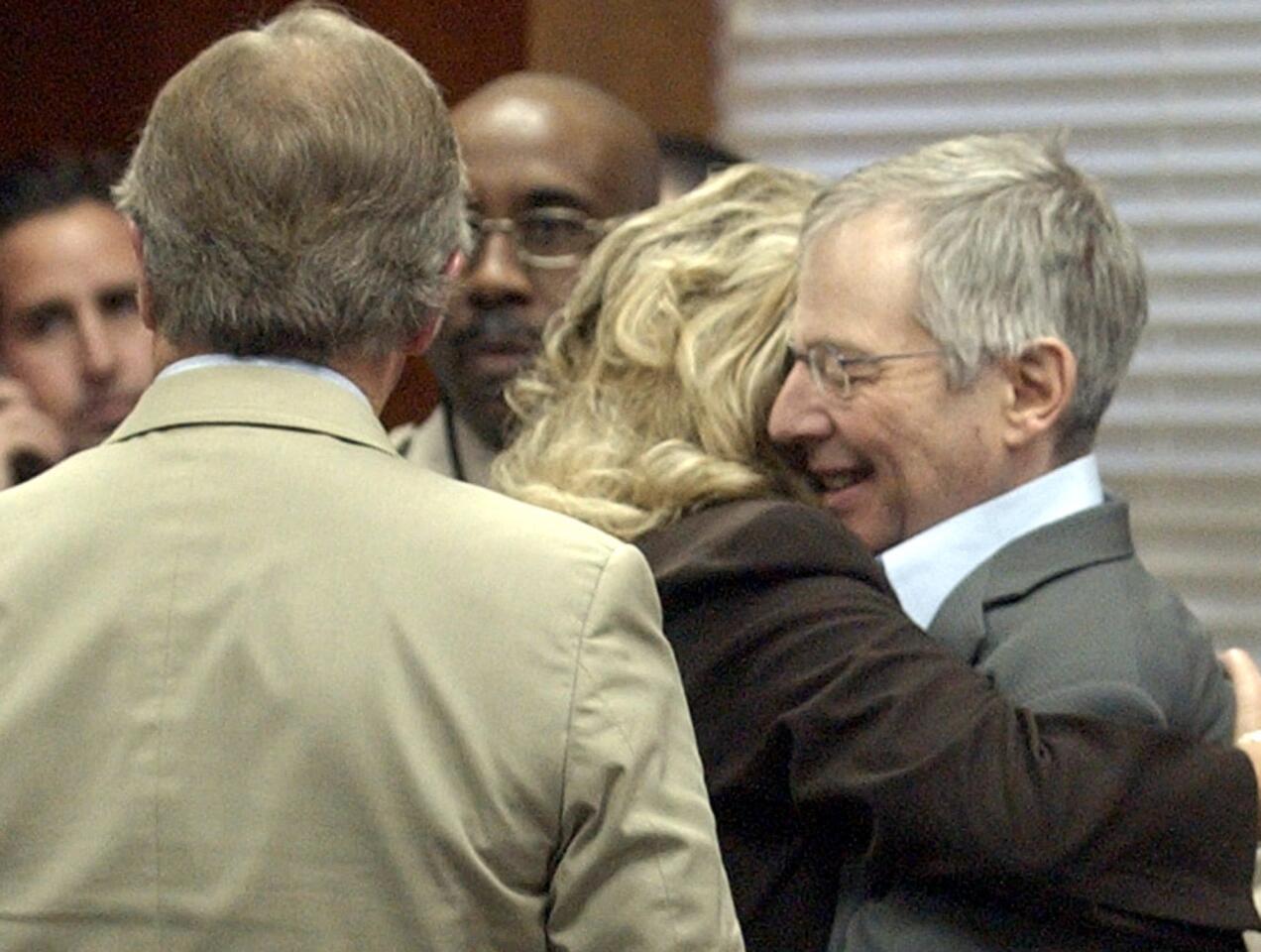 Multi-millionaire murder defendant Robert Durst, right, hugs defense team member Pat Benken after a not guilty verdict Tuesday, Nov. 11, 2003, in Galveston, Texas.