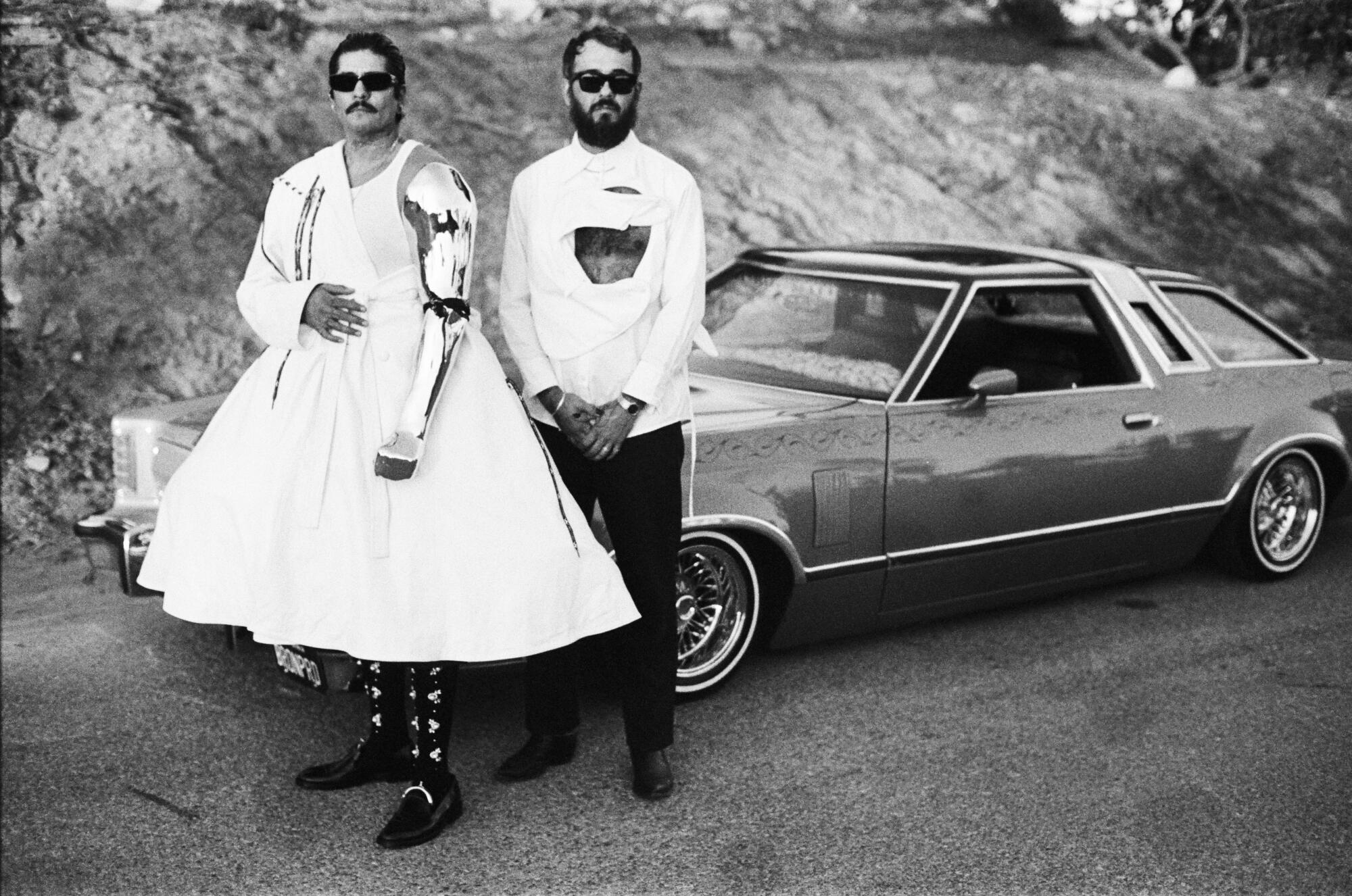 rafa esparza and Timo Fahler, posing in front of lowrider car