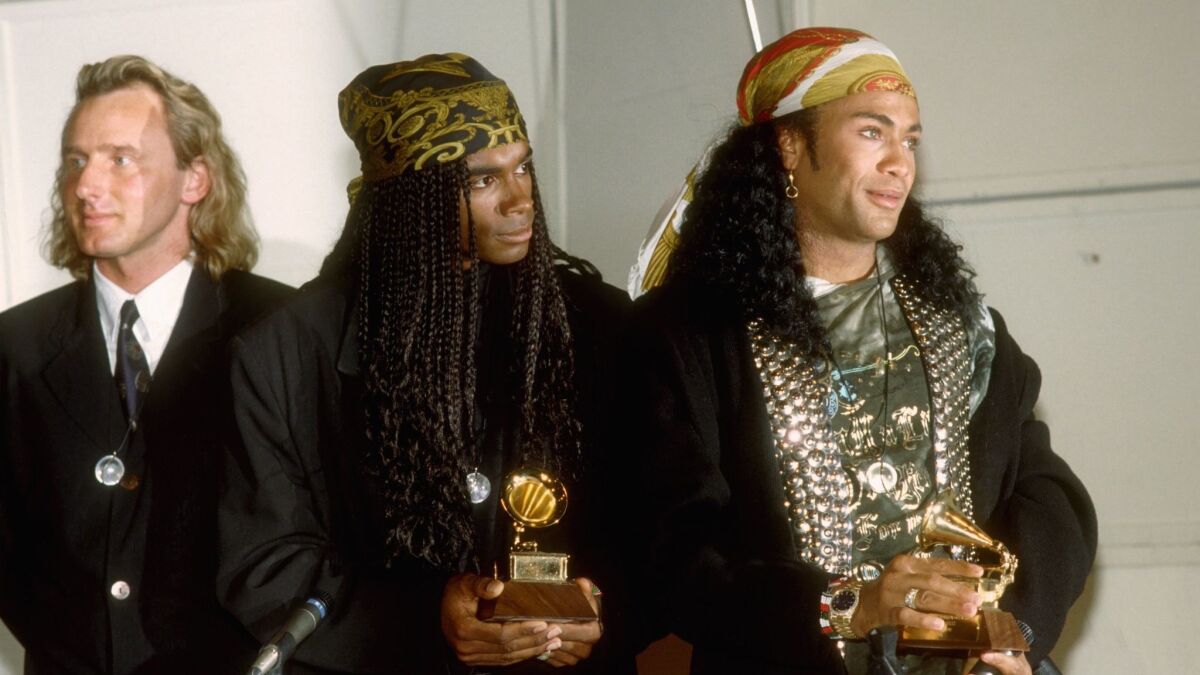 Music producer Frank Farian, left, with Milli Vanilli's Fabrice "Fab" Morvan and Rob Pilatus at the 1990 Grammy Awards in Los Angeles.