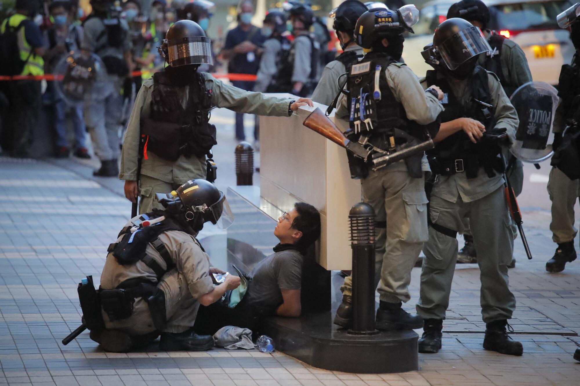 Hong Kong police detain a security law protester on Wednesday.