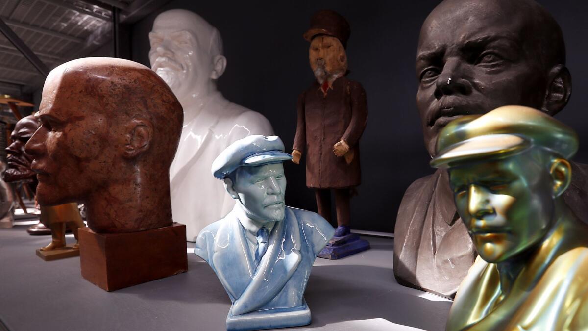 Busts of Lenin line a shelf.