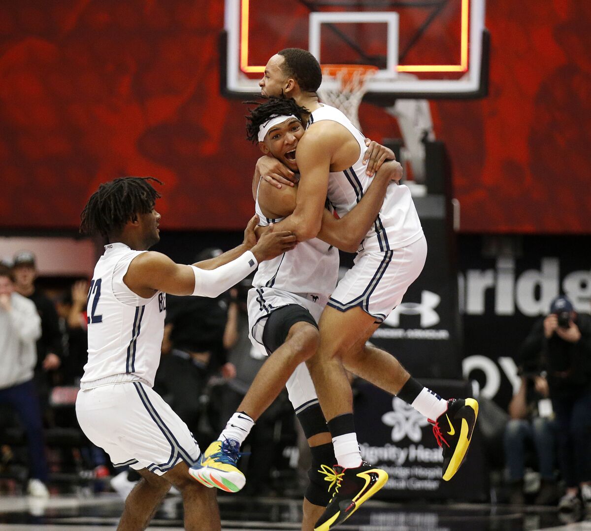Ziaire Williams, with headband, celebrates with Sierra Canyon teammates Amari Bailey, right, and Tookey Wigington (22) after making the game-winning basket as time expired against Etiwanda in the Southern California Open Division final on March 10 at Cal State Northridge.