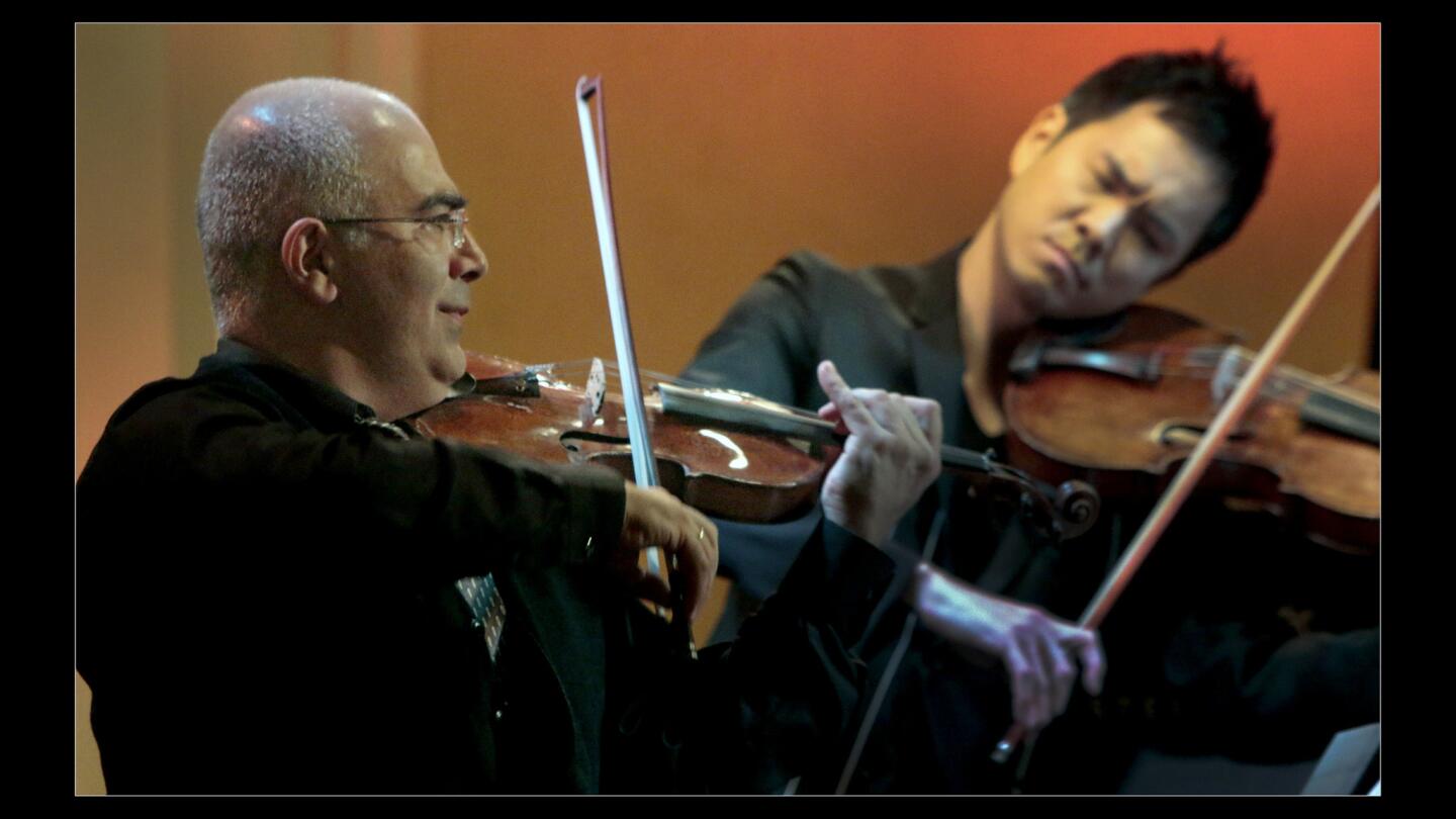 Movses Pogossian, left, and Richard Yongjaei O'Neill of Camerata Pacifica in the world premiere of "String Trio" by composer John Harbison at the Pasadena Civic Auditorium.