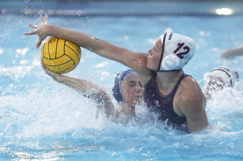 Laguna Beach's Ava Knepper (12) blocks a scoring attempt by Newport Harbor's Taylor Smith.
